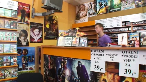 High heeled mature gets cum on tits while fucking in a dvd store