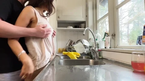 Horny wife gets fucked in the kitchen while doing the dishes