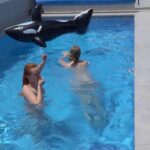 Two girls are having fun in the pool