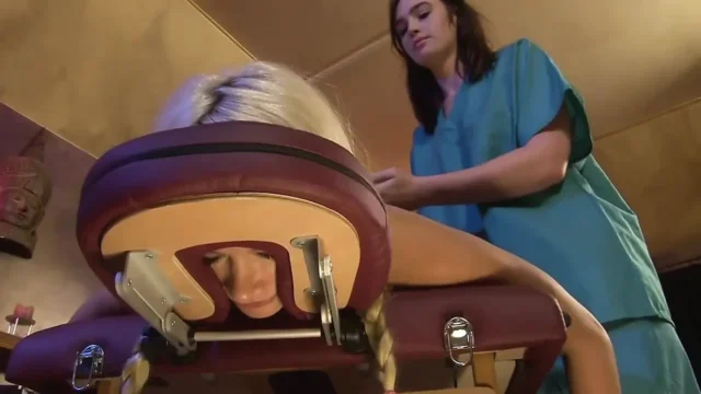 Lesbian masseuse fucks a sexy blonde client with a strapon