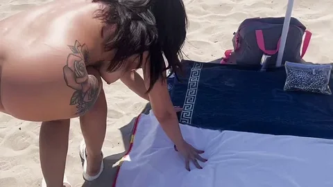 Wife on a public beach, fingering until she squirts.